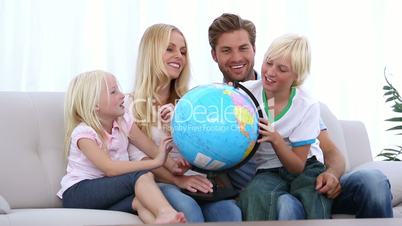 Family looking at globe together