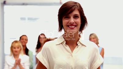 Buisnesswomen applauding colleague