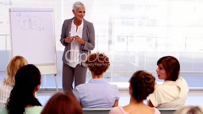 Businesswoman giving a lecture to other businesswomen