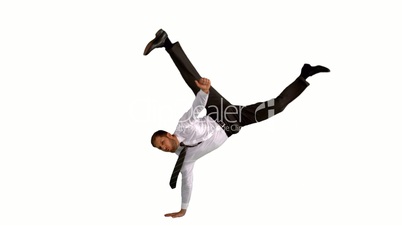 Businessman doing handstand with legs outstretched