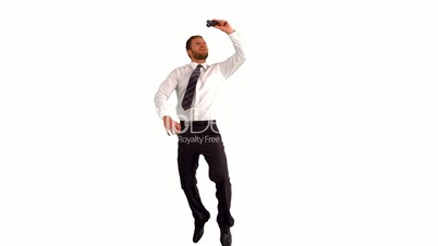 Businessman jumping up and taking self portrait