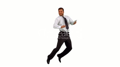 Businessman jumping up holding tablet