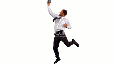 Businessman jumping up holding tablet pc
