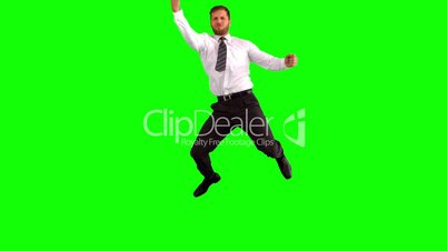 Businessman jumping and punching the air