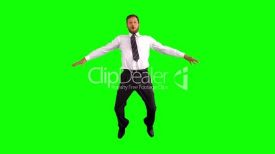 Businessman jumping and stretching his body towards the camera