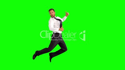 Businessman jumping and giving thumbs up