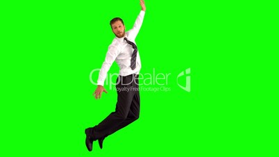 Businessman jumping and grabbing his legs