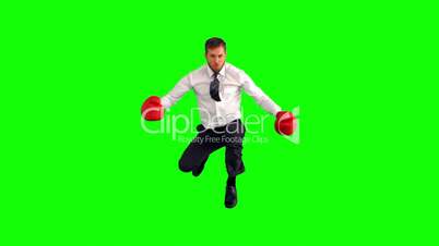 Businessman leaping with boxing gloves and hitting fists together