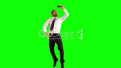 Businessman taking self portrait while leaping