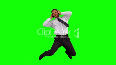 Businessman listening to music while jumping