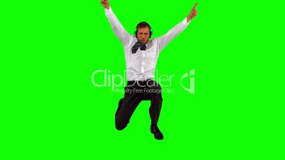 Businessman listening to music while jumping up and cheering