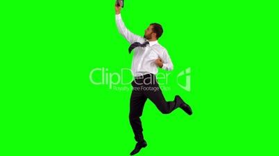 Businessman holding tablet pc jumping up