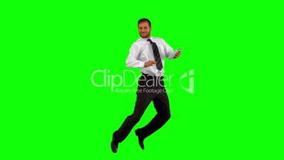 Businessman holding tablet pc jumping