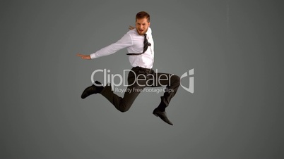 Businessman jumping on grey background