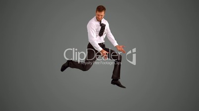 Businessman leaping on grey background