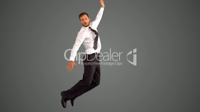 Businessman leaping up and grabbing legs on grey background