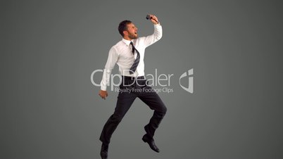 Businessman jumping and taking self portrait on grey background