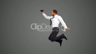 Businessman leaping and holding binoculars on grey background