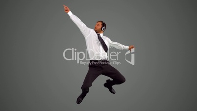 Businessman jumping and listening to music and disco dancing
