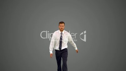 Businessman walking towards camera and shouting angrily on grey background