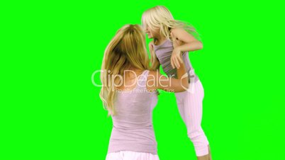 Mother lifting and spinning her daughter on green screen