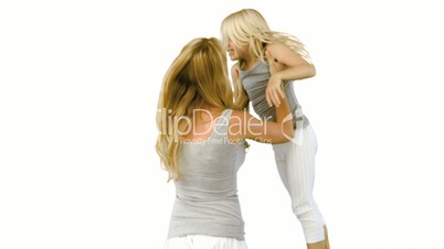 Mother lifting and spinning her daughter on white background