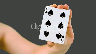 Hand shuffling and pushing cards towards the camera
