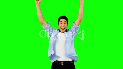 Man jumping for joy on green screen