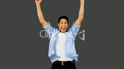 Man jumping for joy on grey background