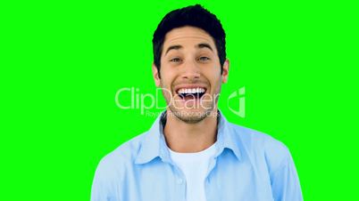 Man laughing at the camera on green screen