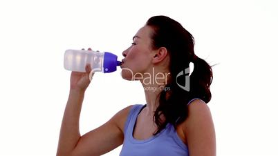 Woman drinking water on the beach