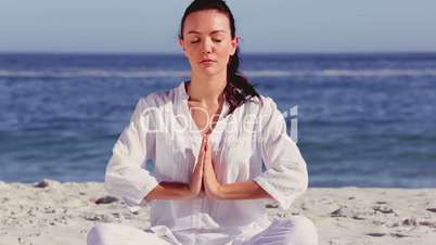 Woman meditating in sukhasana pose