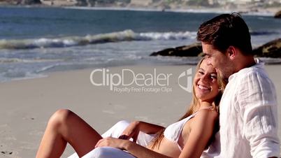 Attractive couple relaxing on the beach