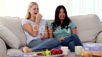 Friends watching something funny on tv