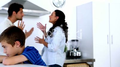 Little boy feeling sad as parents fight