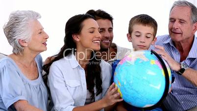 Extended family looking at globe together