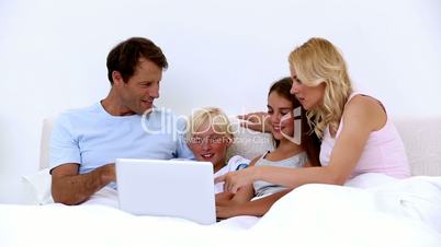 Cute family using laptop together