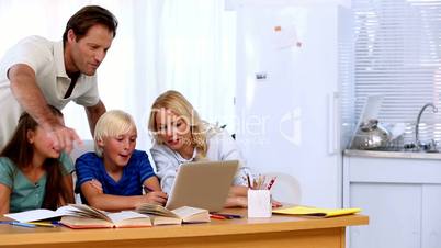 Family using the laptop together to do homework