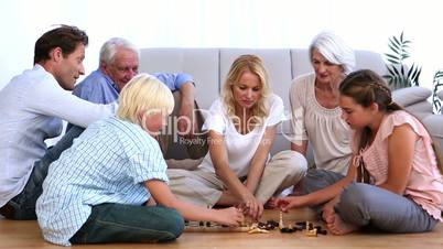 Family playing chess at home