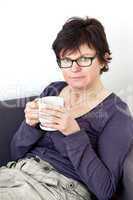 Woman with cup looking pensive