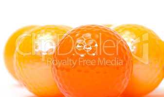 Orange and golden golf balls