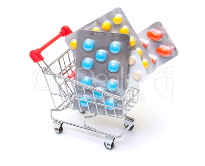 Multicolored pills packs in shopping cart