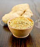 Ginger powder in a bowl with the root