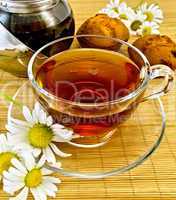 herbal tea with daisies and kettle