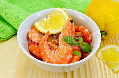 shrimp in a white bowl with lemon slices