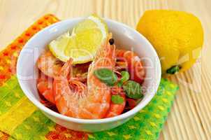shrimp in a white bowl with lemon
