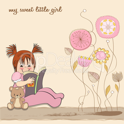 sweet little girl reading a book