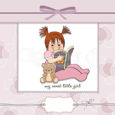 sweet little girl reading a book