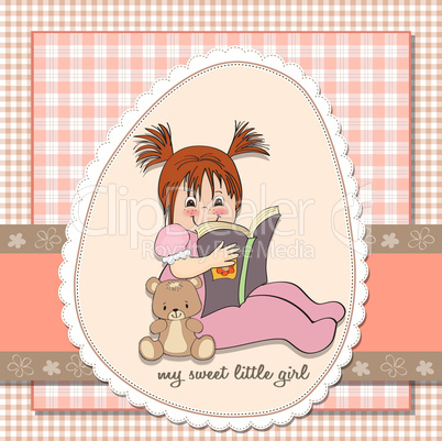 sweet little girl reading a book