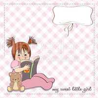 sweet little girl reading a book